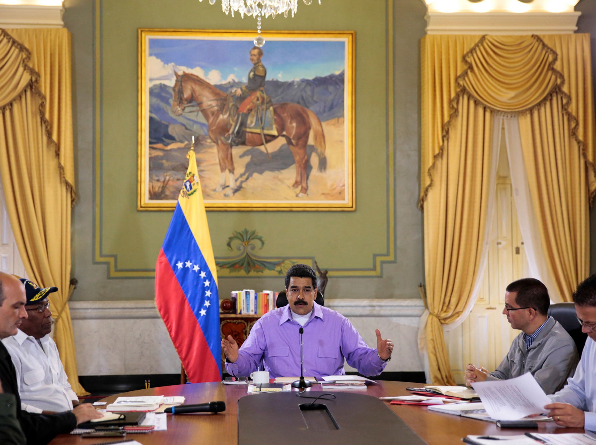 Venezuela's President Nicolas Maduro (C) speaks during a meeting with ministers at Miraflores Palace in Caracas