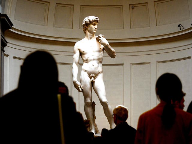 <p>People look at the original 16th century statue of David by Italian artist Michelangelo Buonarroti in the Galleria dell'Accademia on April 9, 2015 in Florence</p>