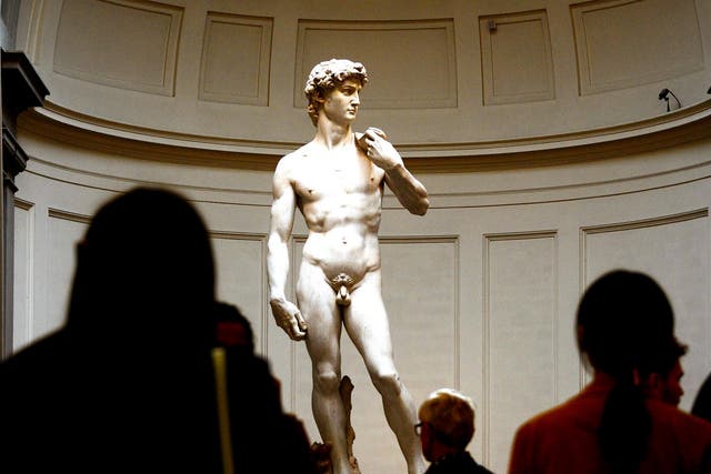 <p>People look at the original 16th century statue of David by Italian artist Michelangelo Buonarroti in the Galleria dell'Accademia on April 9, 2015 in Florence</p>