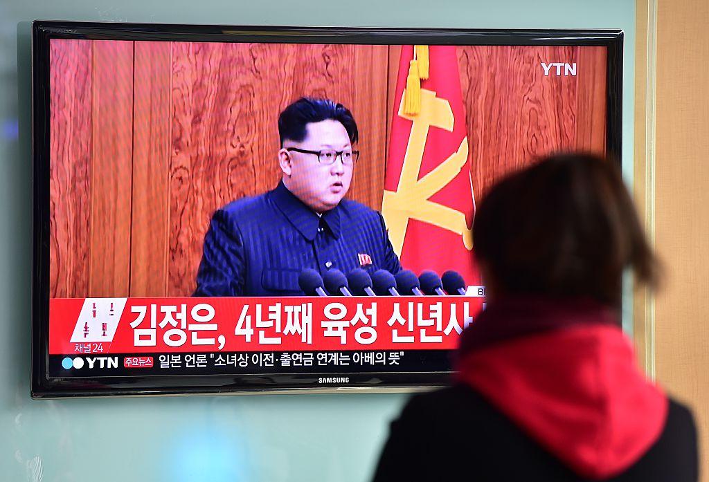 A woman watches a televised broadcast of North Korean leader Kim Jong-Un's New Year speech, at a railroad station in Seoul on January 1, 2016.
