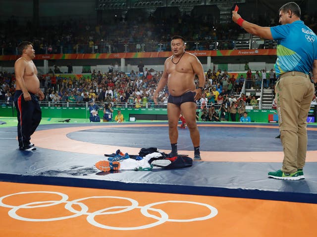 Coaches protest after Mandakhnaran Ganzorig of Mongolia is defeated by Ikhtiyor Navruzov in the men's Freestyle 65kg bronze match