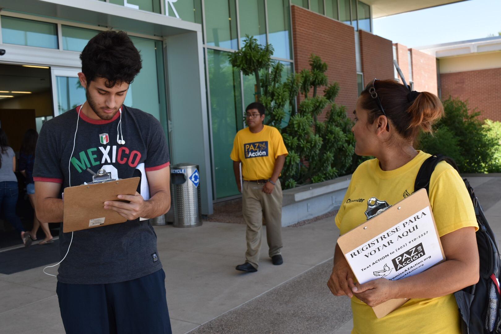 Promise Arizona volunteers Jose Barboza (centre) and Maria Laris (right) registering new voters at Phoenix College (Tim Walker)