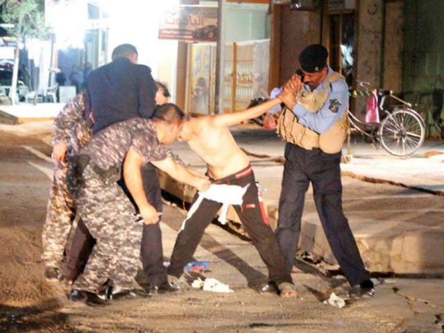 Iraqi security forces remove a suicide vest from a boy in Kirkuk, Iraq, 21 August, 2016.