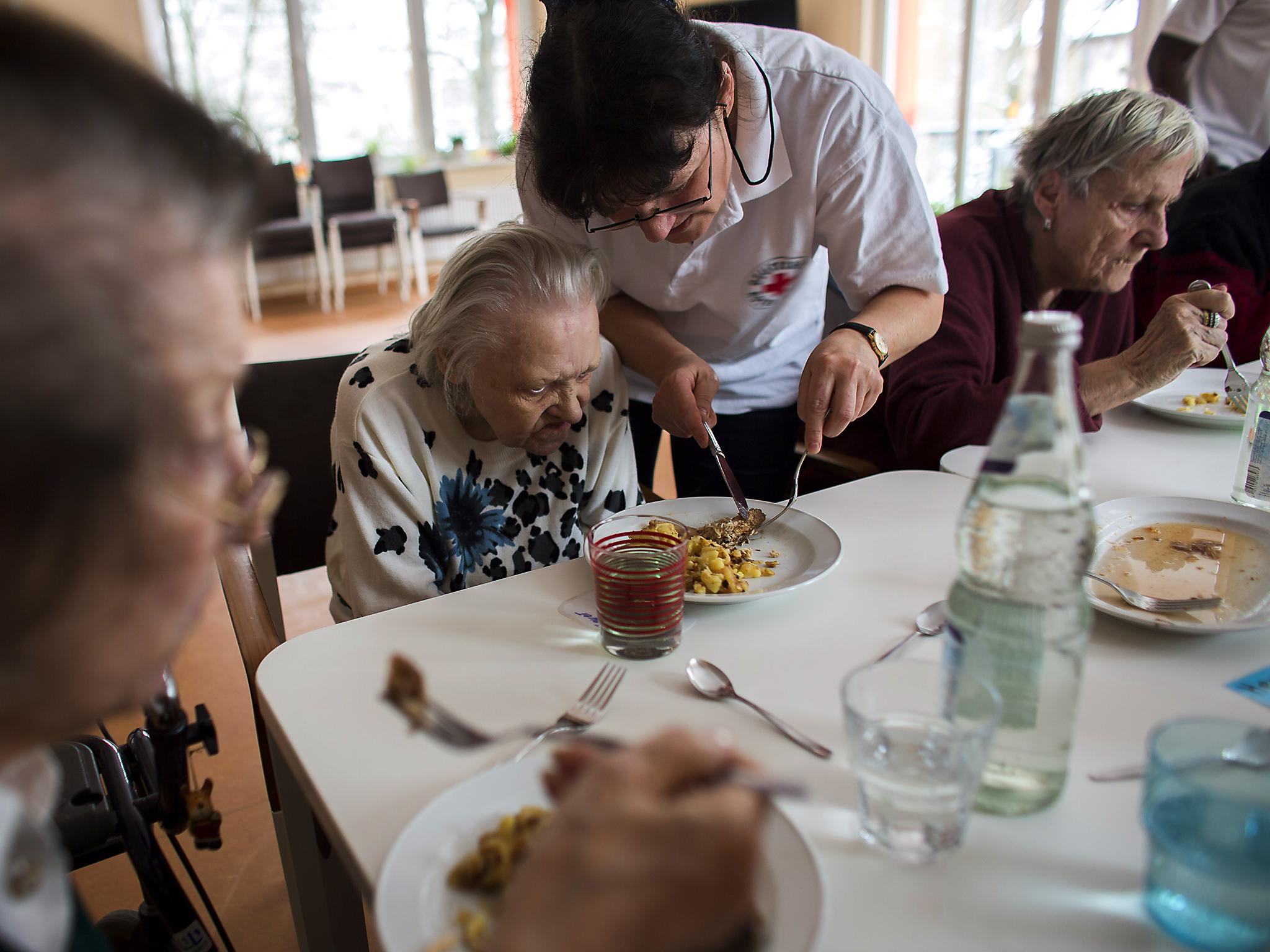 Carers working for the German Red Cross support dementia sufferers. The disease is now the leading cause of death in the UK