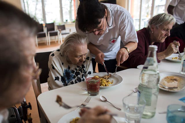 Carers working for the German Red Cross support dementia sufferers. The disease is now the leading cause of death in the UK