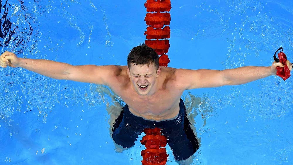 Adam Peaty celebrates his record-breaking gold medal