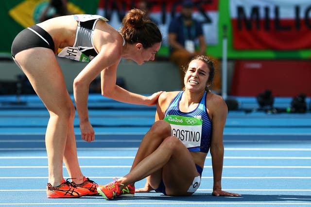 Hamblin tends to D'Agostino after the pair fell during the 5,000 metre qualifier