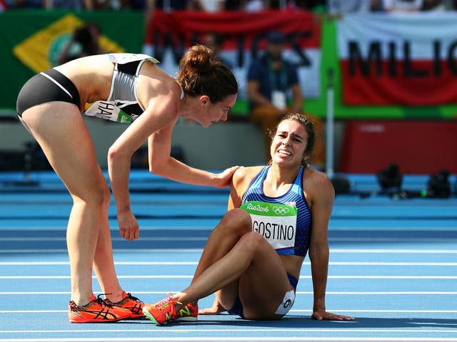 Hamblin tends to D'Agostino after the pair fell during the 5,000 metre qualifier