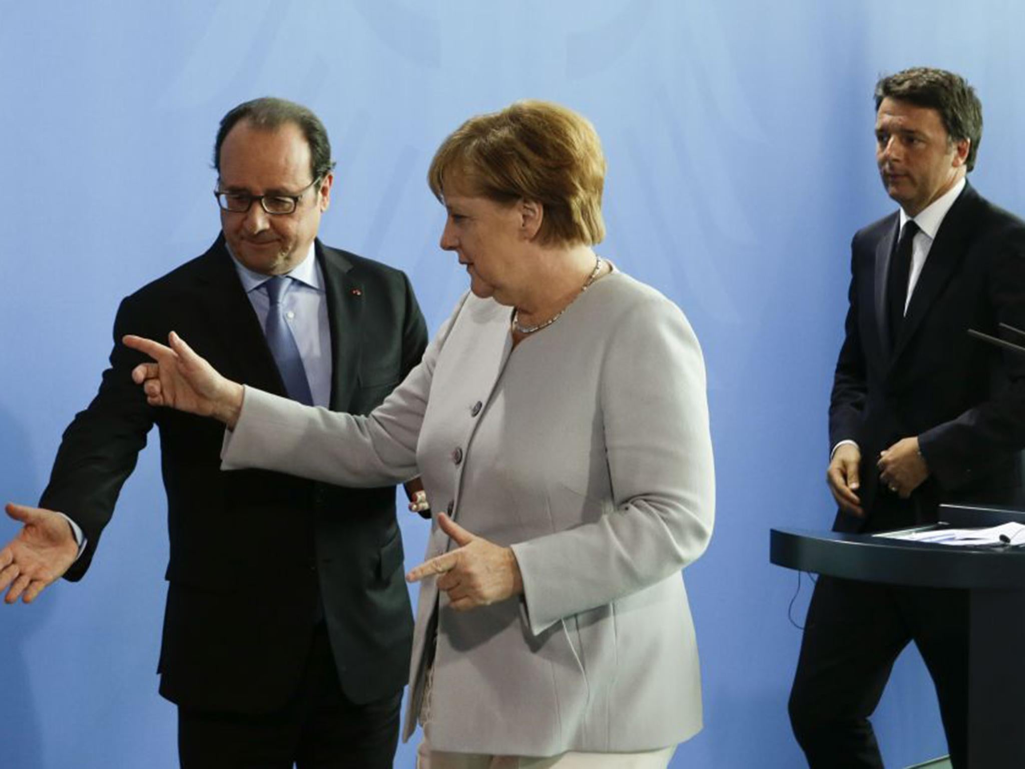 German Chancellor Angela Merkel, center, the Prime Minister of Italy Matteo Renzi, right, and the President of France Francois Hollande, left, leave a news conference during a meeting at the chancellery in Berlin in June
