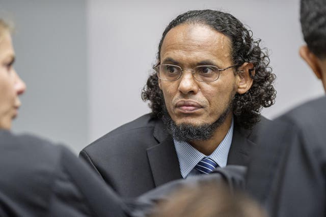 Ahmad Al Faqi Al Mahdi, center, appears at the International Criminal Court in The Hague, Netherlands