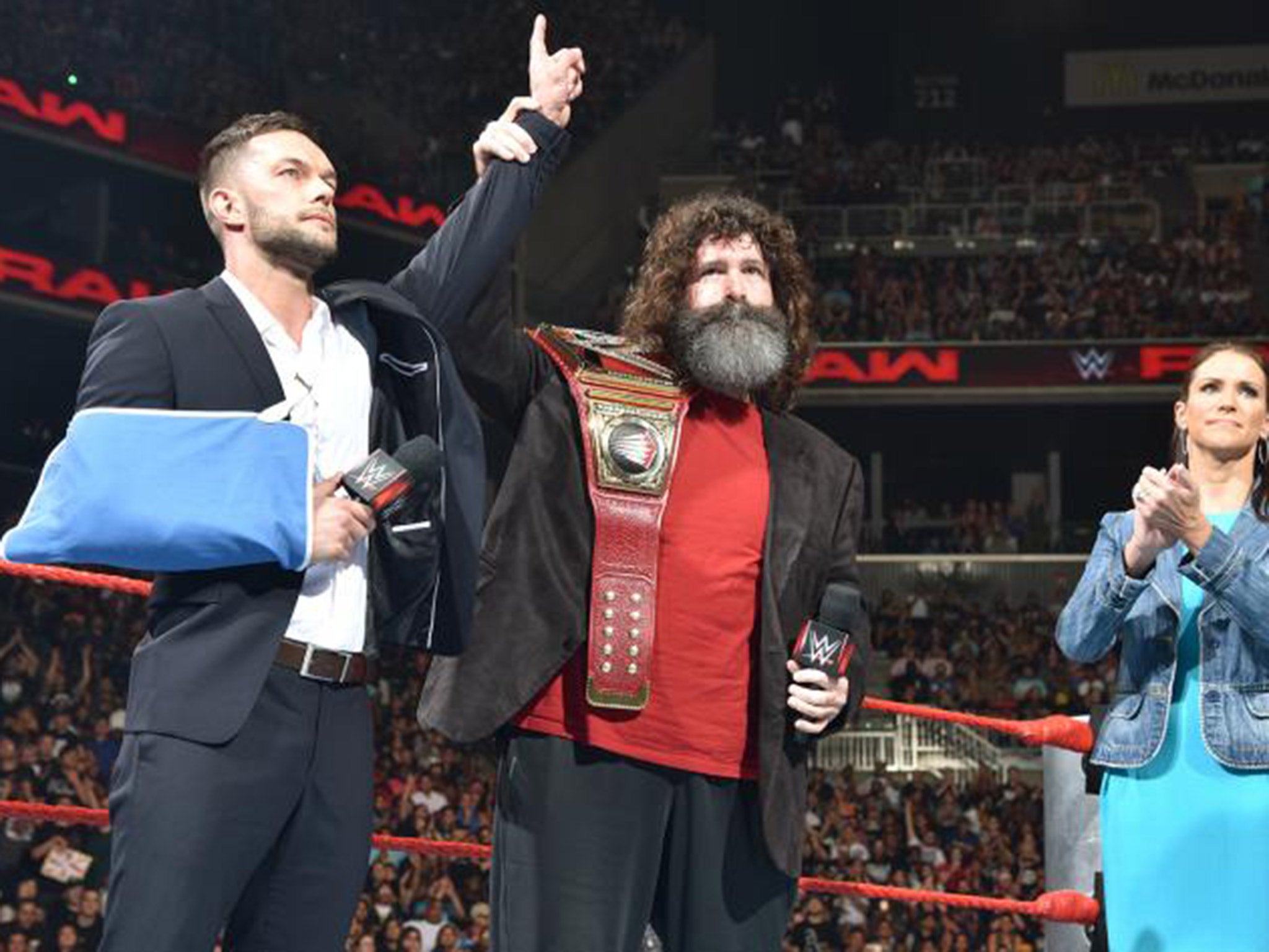 Finn Balor relinquishes his WWE Universal Championship to Mick Foley and Stephanie McMahon