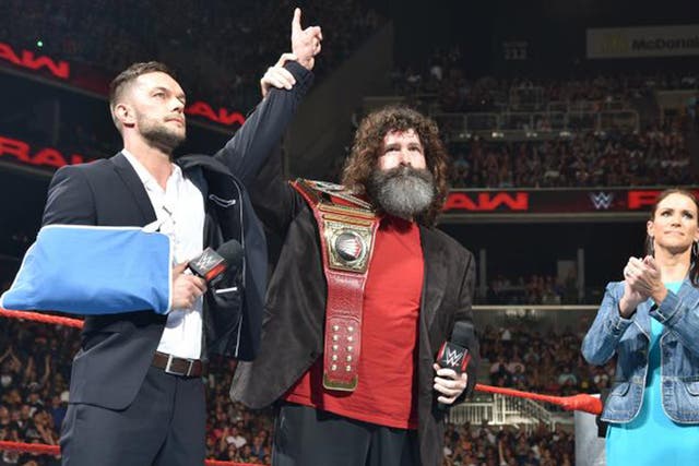 Finn Balor relinquishes his WWE Universal Championship to Mick Foley and Stephanie McMahon
