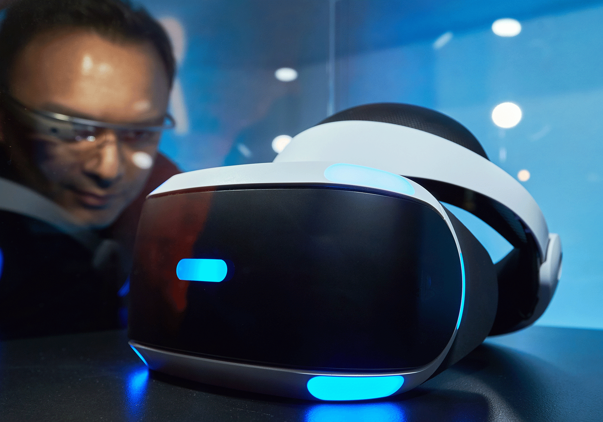 A gamer wearing Google Glass observes the Playstation VR virtual reality headset - Google is investing heavily in VR films