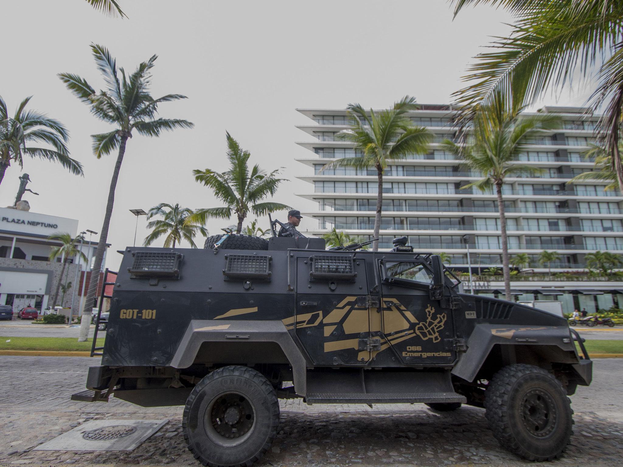 An armoured state police vehicle patrols outside of the restaurant, La Leche, after the kidnapping of El Chapo's son Hector Guerrero/Getty