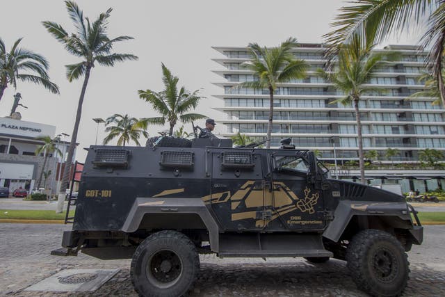 An armoured state police vehicle patrols outside of the restaurant, La Leche, after the kidnapping of El Chapo's son <em>Hector Guerrero/Getty</em>