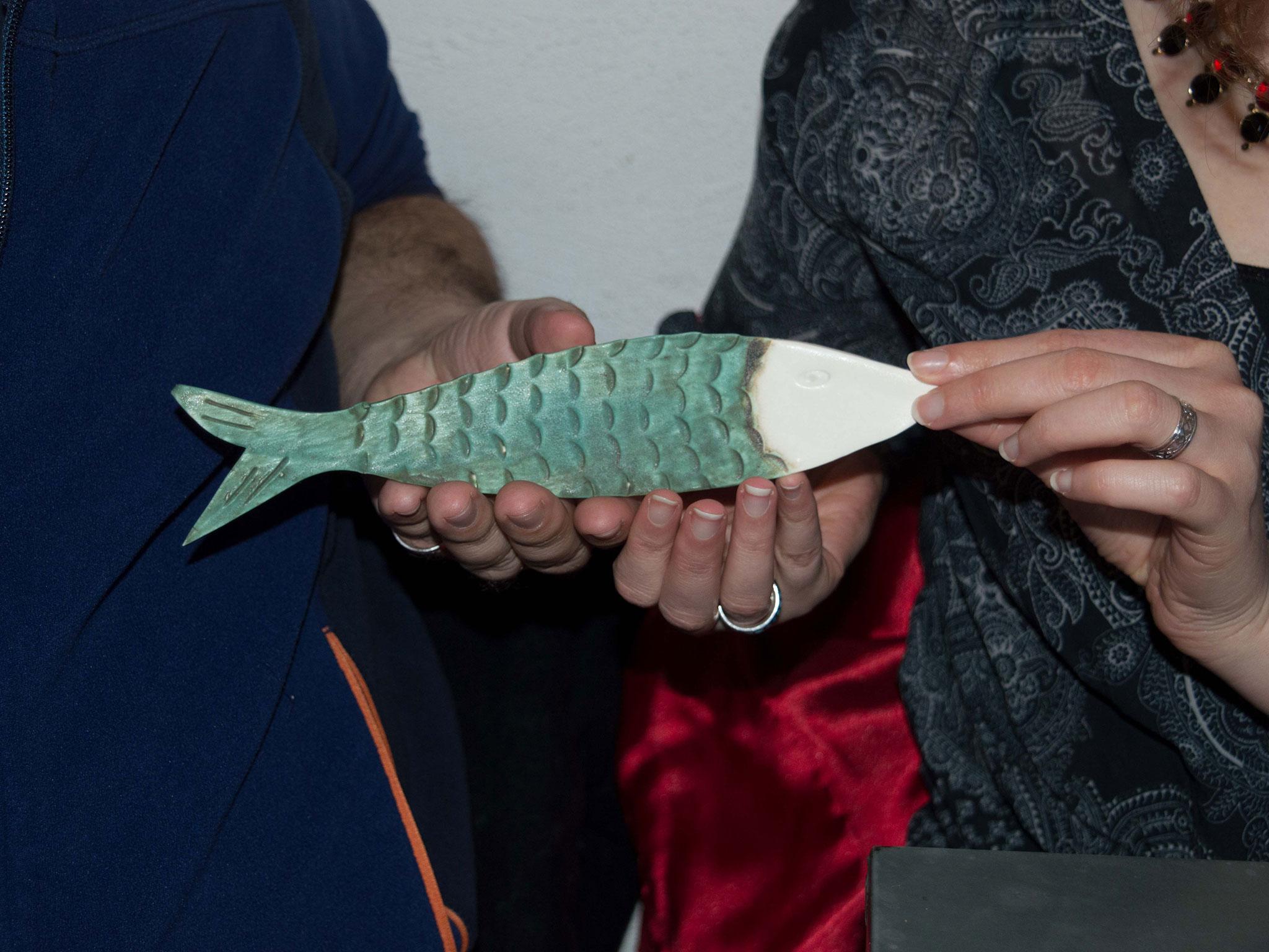 Freya and Dominique hold a fish they bought on holiday together. Clarke-Salt often asks couples to talk about important objects to help them open up