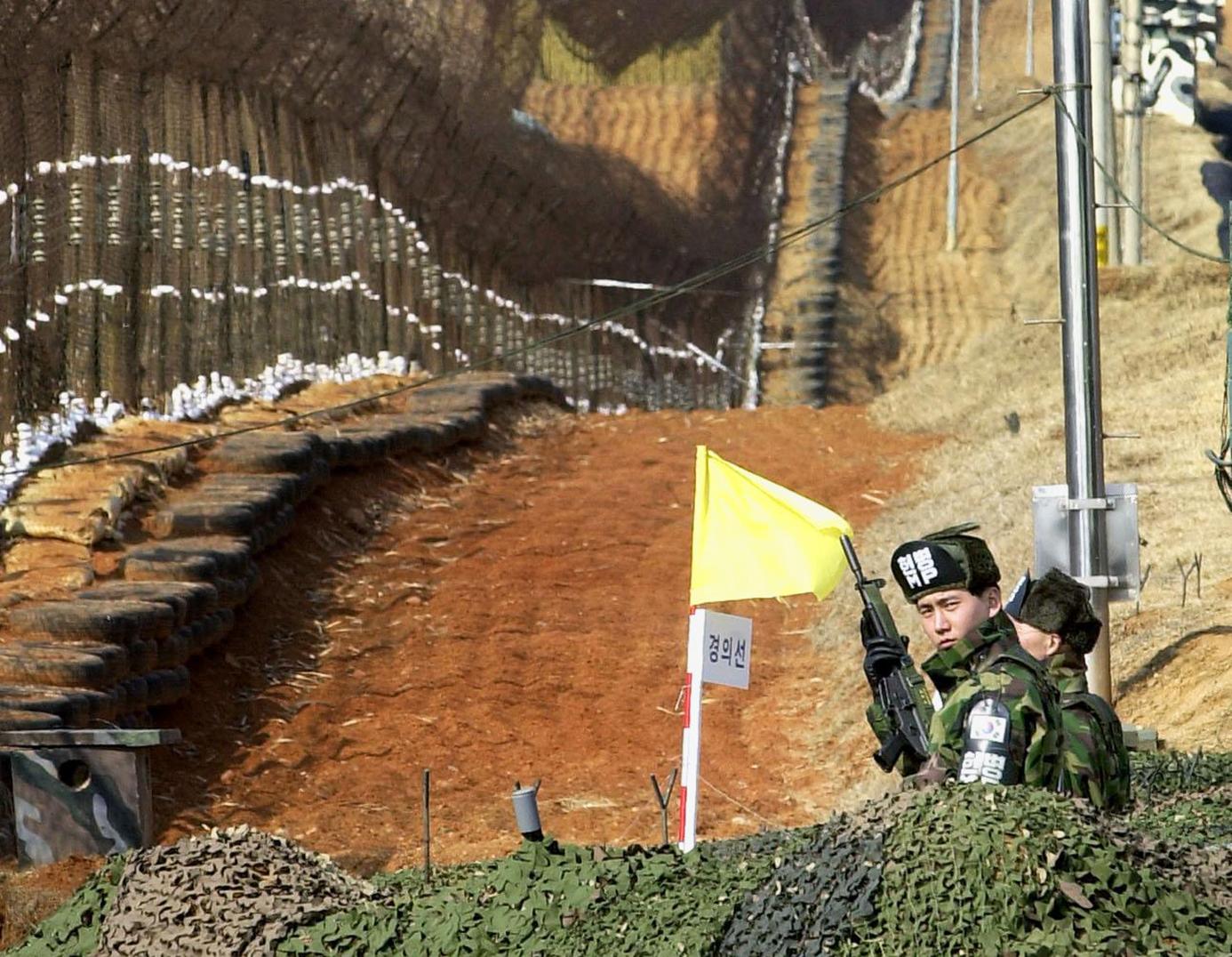 Soldiers from the South man their post along the barbed wire fence inside the DMZ that divides the two Koreas