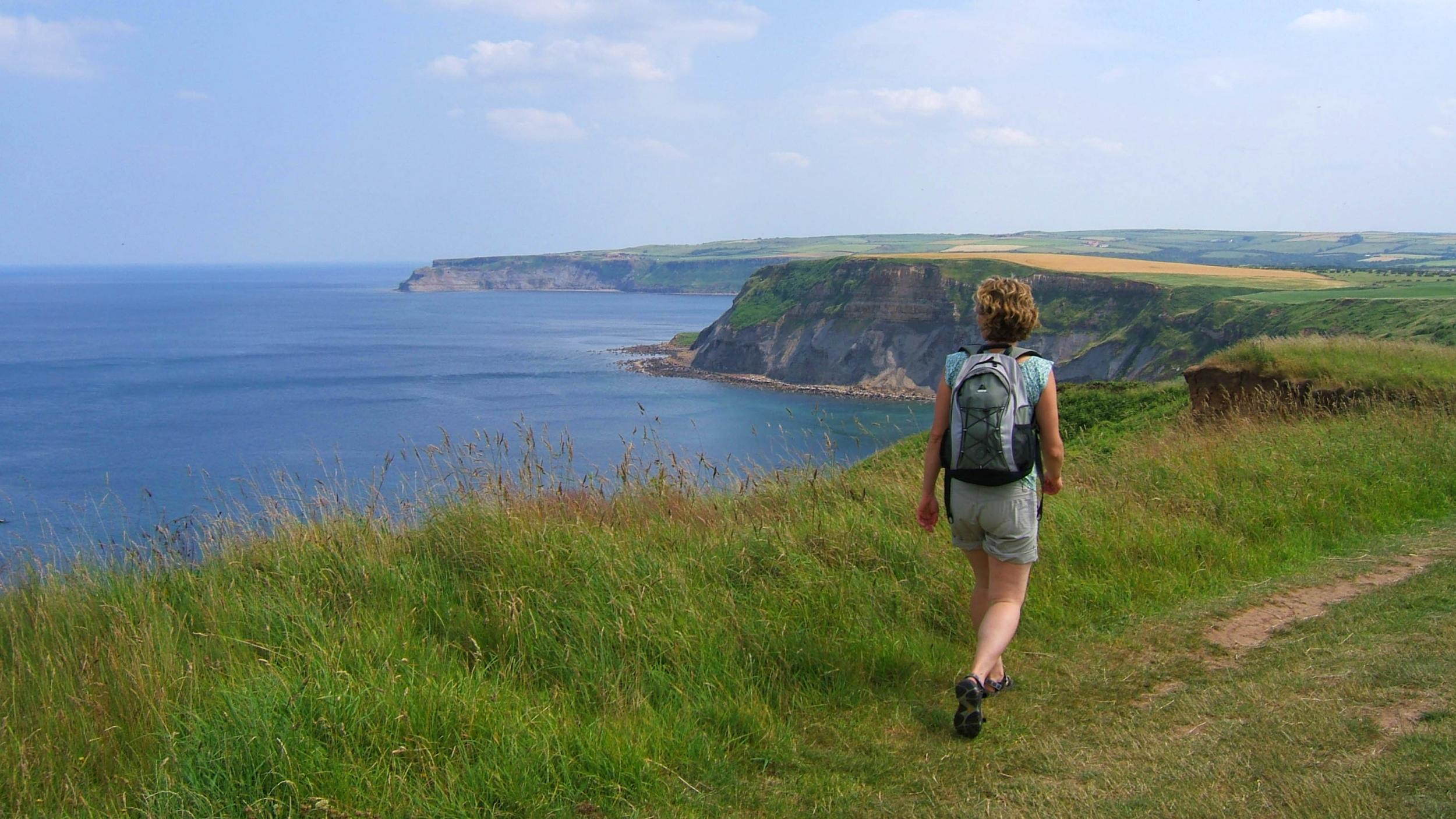 A walker on the Cleveland Way, just south of Staithes, and looking out to the North Sea