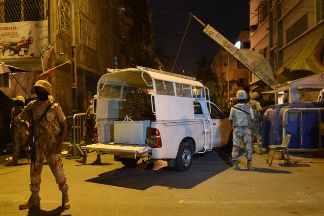 Pakistani paramilitary Rangers cordon off a street leading to the MQM headquarters in Karachi on Monday night