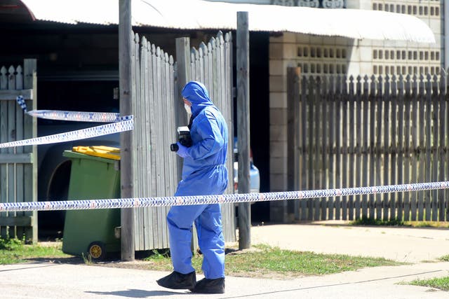 Police forensics at the scene of a knife attack at a hostel complex
