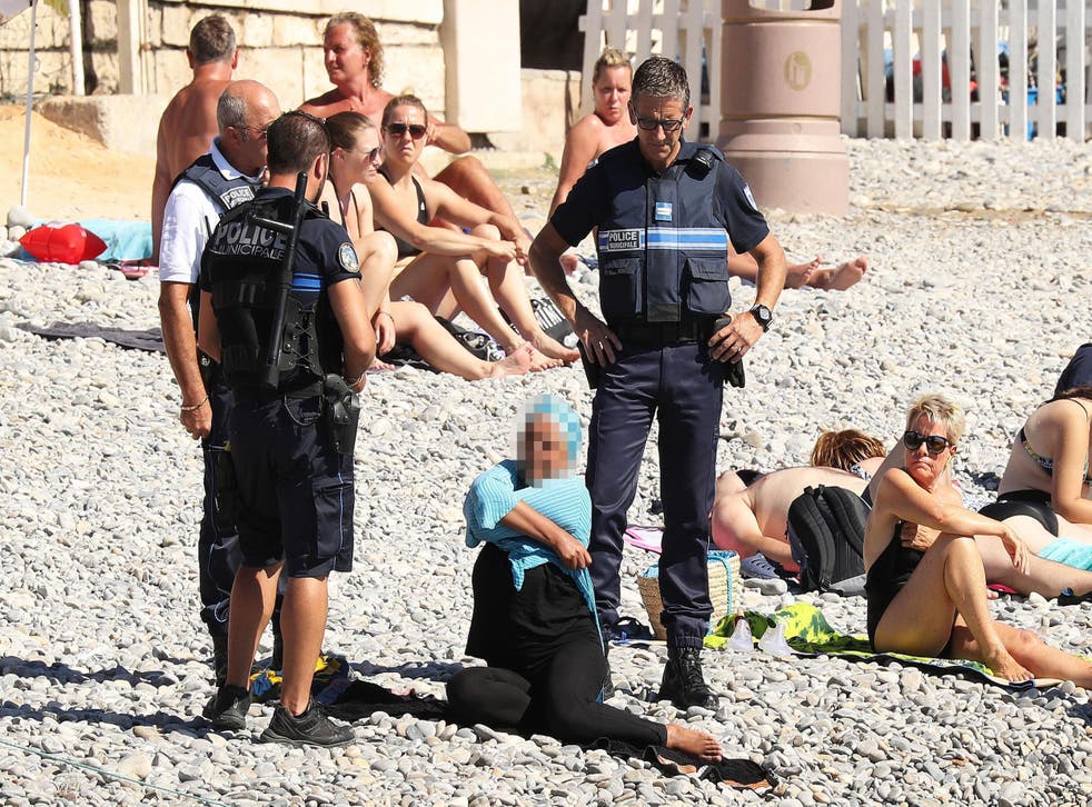 Armed police in Nice forced a woman on a beach to remove her burkini, sparking outrage online