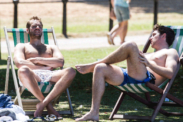 Men relax in the sun in Hyde Park in London. Temperatures in the capital are expected to hover around 30 C while Manchester will see mid- to low- 20s