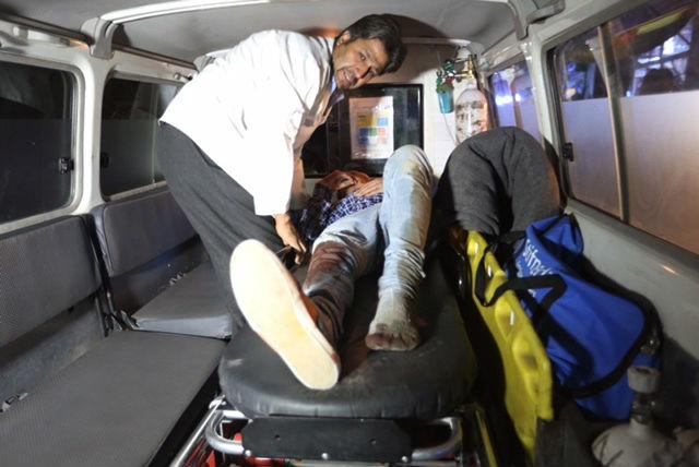 One injured person is carried to an ambulance