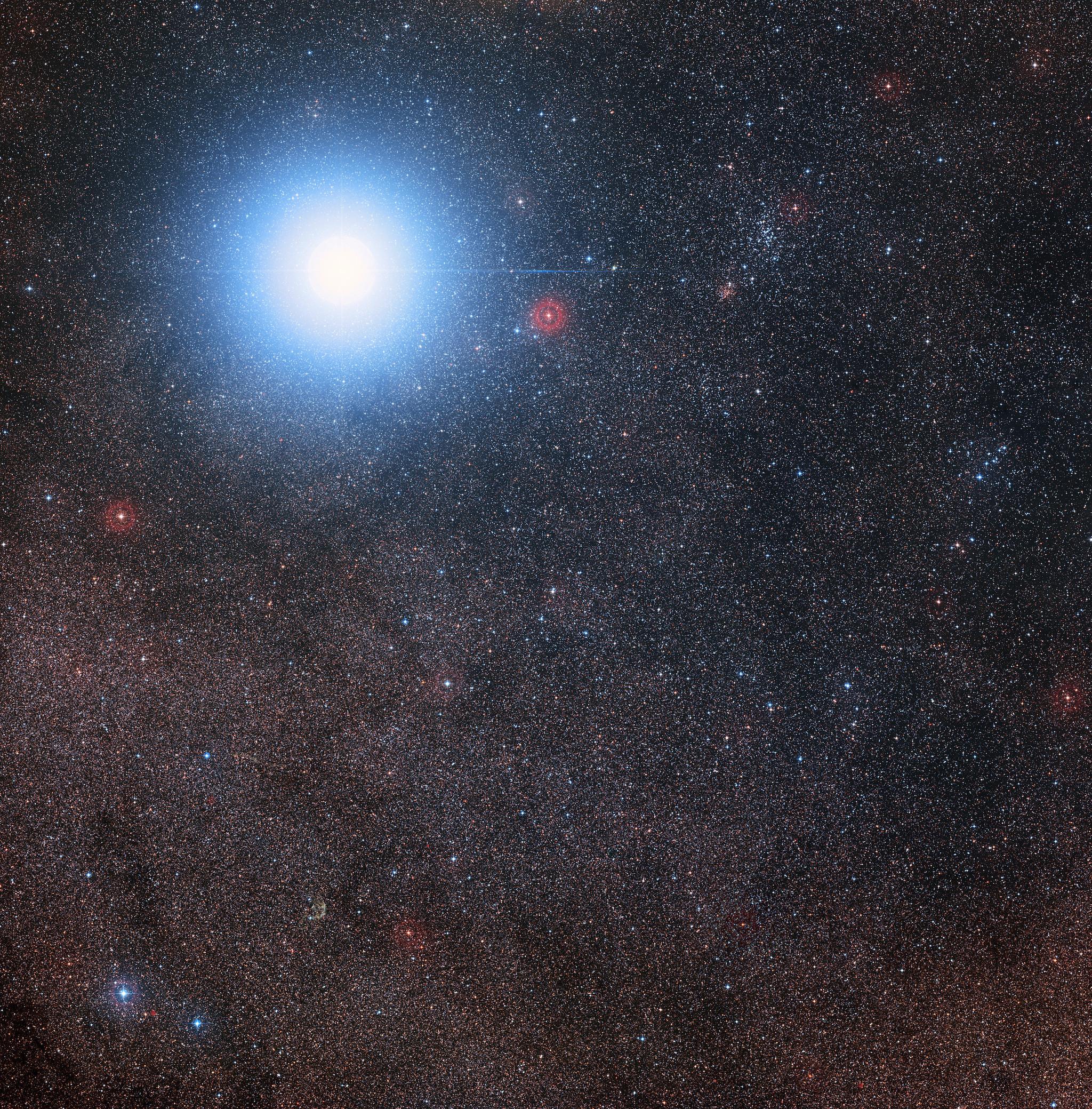 This image of the sky around the bright star Alpha Centauri AB also shows the much fainter red dwarf star, Proxima Centauri, the closest star to the Solar System. The picture was created from pictures forming part of the Digitized Sky Survey 2