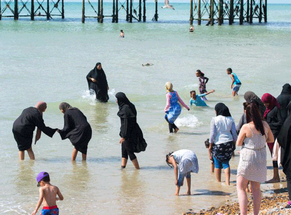 Muslim women cool themselves off in the sea at Brighton