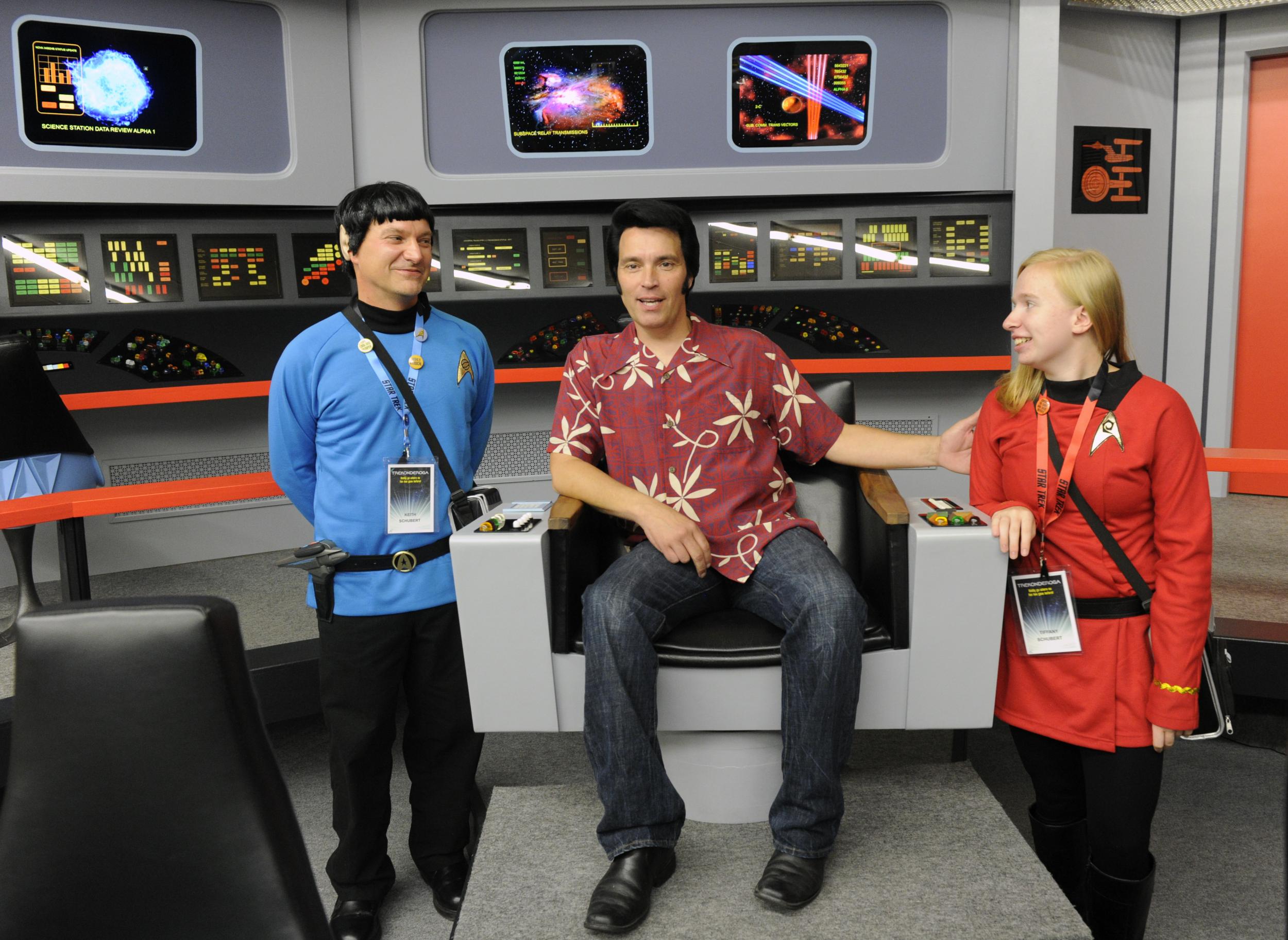 Keith Schubert dressed as Star Trek’s Mr Spock, and his daughter Tiffany Schubert, right, talk with James Cawley during a tour of his replica starship Enterprise from the original Star Trek series
