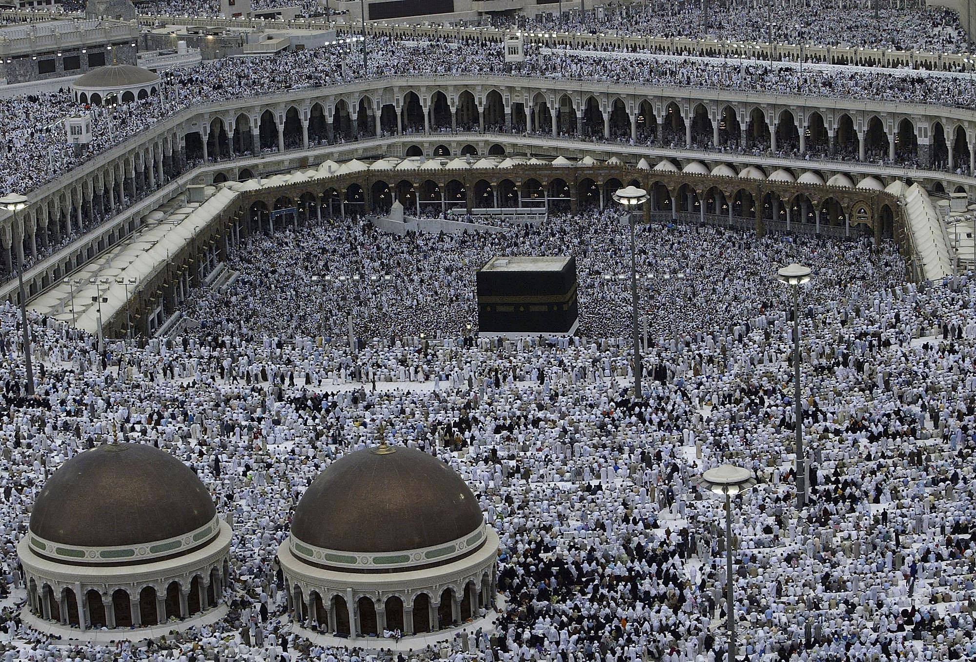 Pilgrims partake in the evening prayer inside the Grand Mosque and Holy Kabba in Mecca, the holiest Muslim site in the world