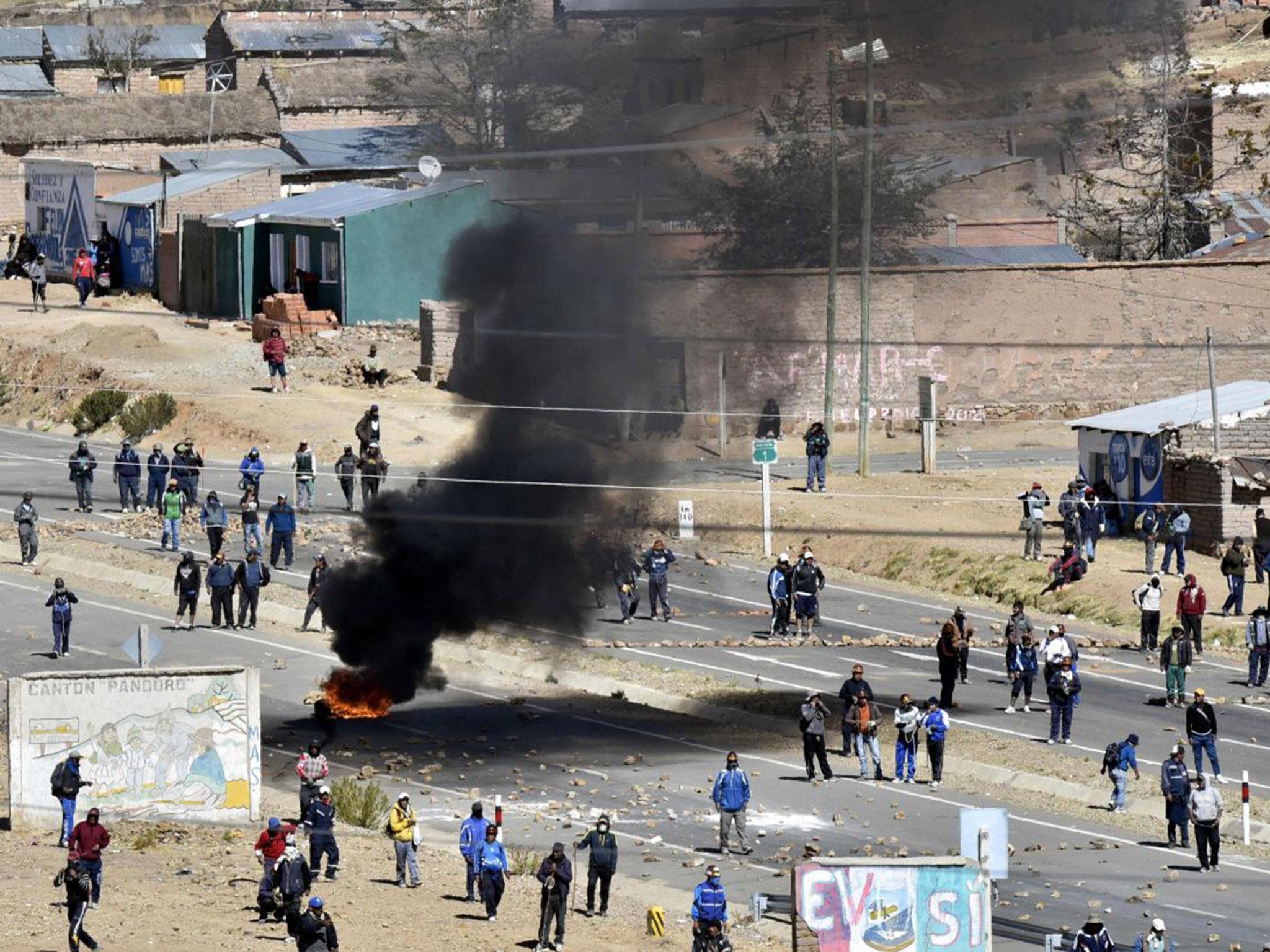 Miners blocked a road (AIZAR RALDES/AFP/Getty)