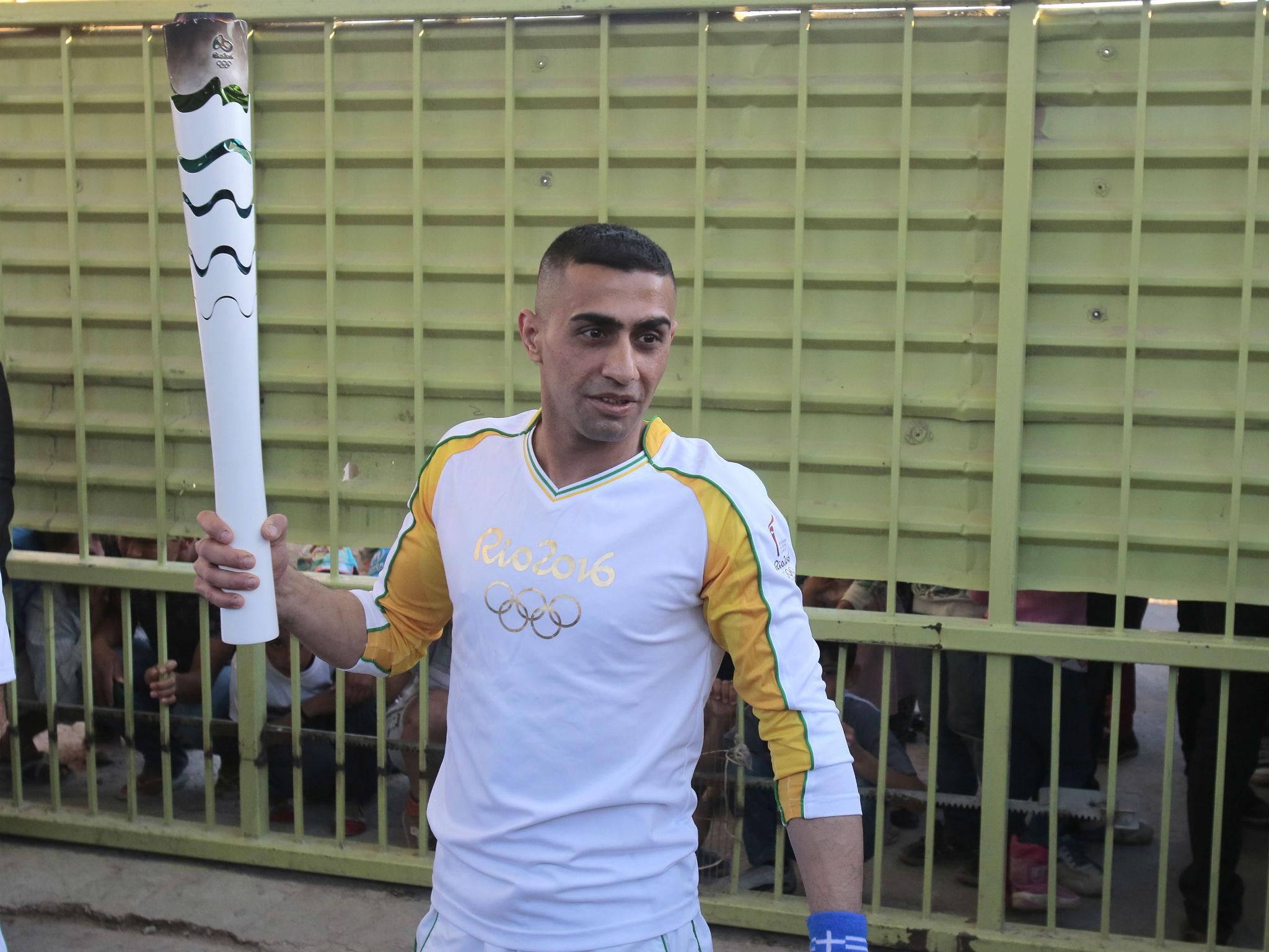 Ibrahim Al-Hussein carrying the Olympic torch