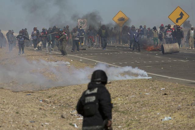 Striking miners clash with police after blocking a highway outside La Paz