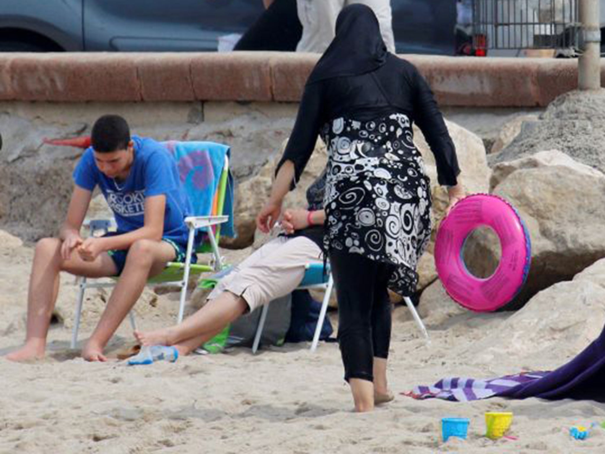 A woman wears a burkini on a beach in Marseille