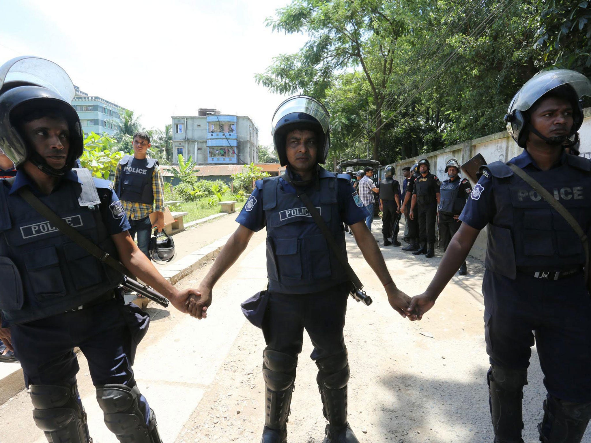 Bangladeshi police guard a house following the raid in Narayanganj