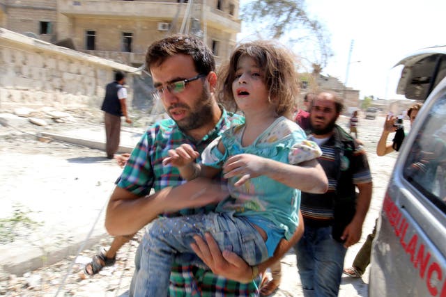 A man carries a girl that survived bombing on the rebel held Bab al-Nayrab neighborhood of Aleppo on 27 August