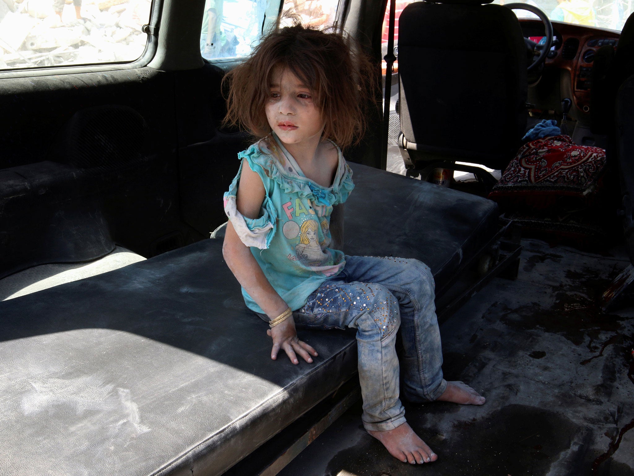A girl who survived bombing on the rebel held Bab al-Nayrab neighborhood of Aleppo on 27 August (Reuters)