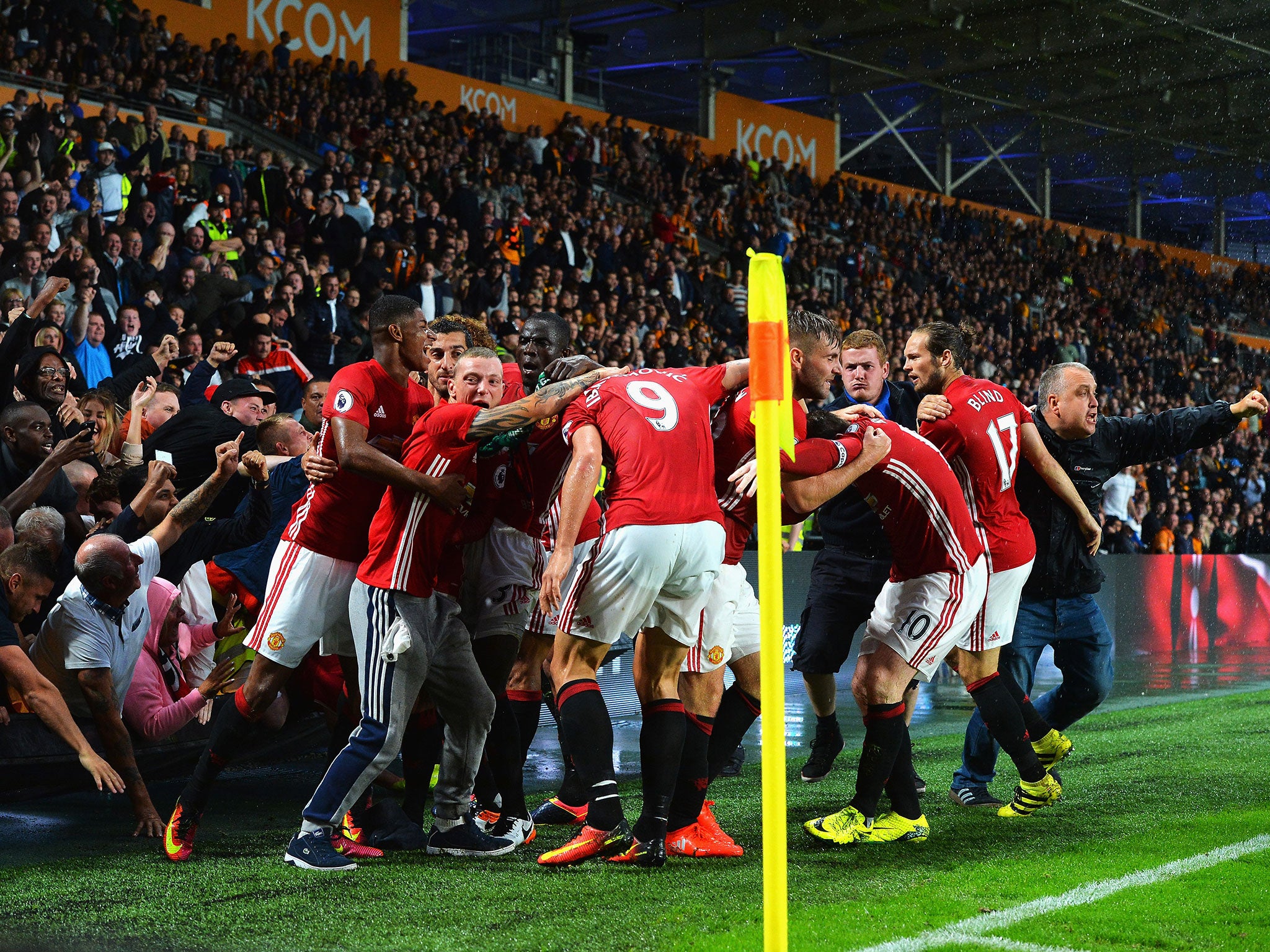 Fans join the Manchester United players in celebration following Rashford's winning goal