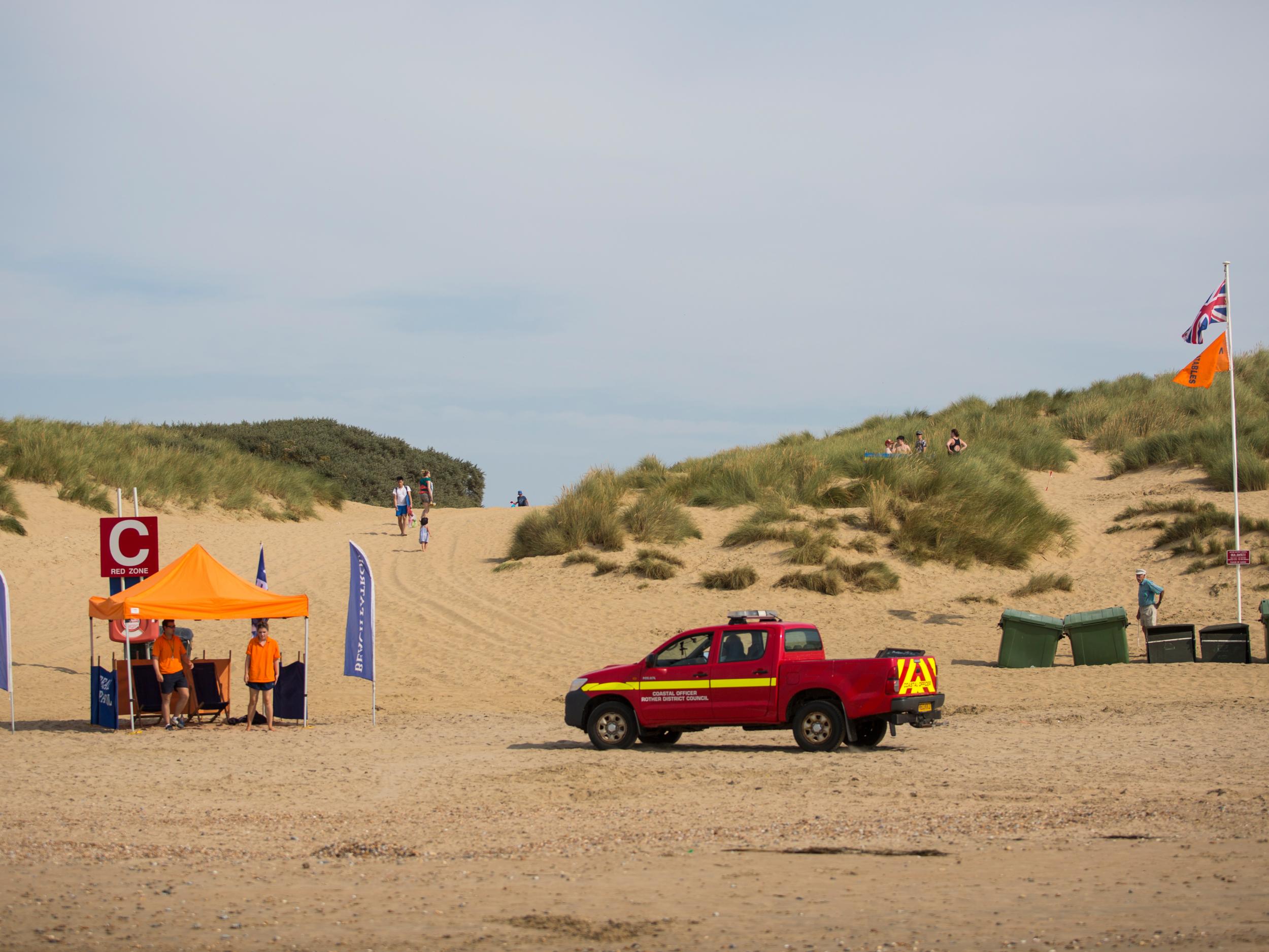 Coastal officers drive towards a beach patrol tent on Camber Sands