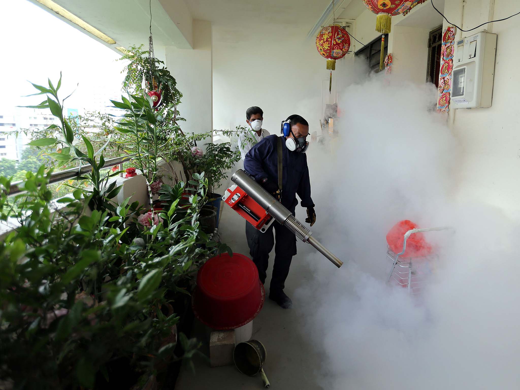 Workers fogging in the housing estate at Aljunied Crescent in Singapore