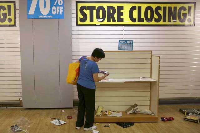 A woman shops in a branch of BHS before its final closure