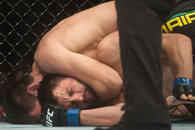 Maia, top, holds Condit in a headlock