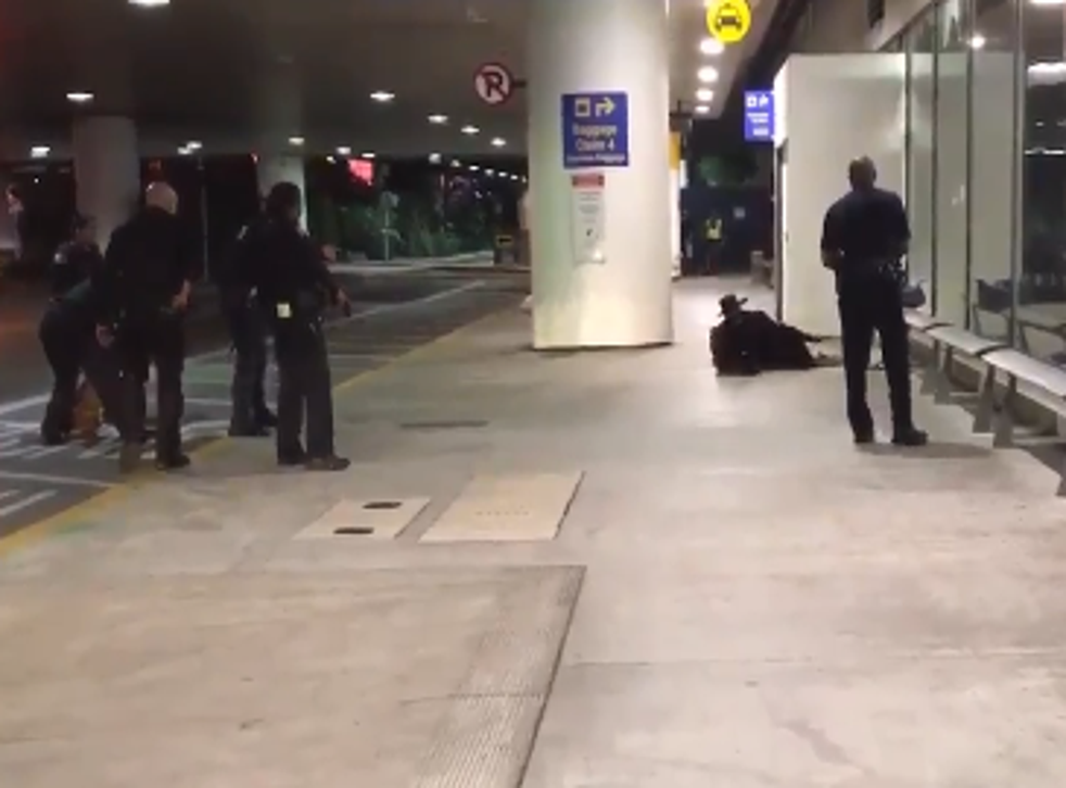 The footage shows a man dressed as Zorro being surrounded by six police officers and ordered to get on the ground