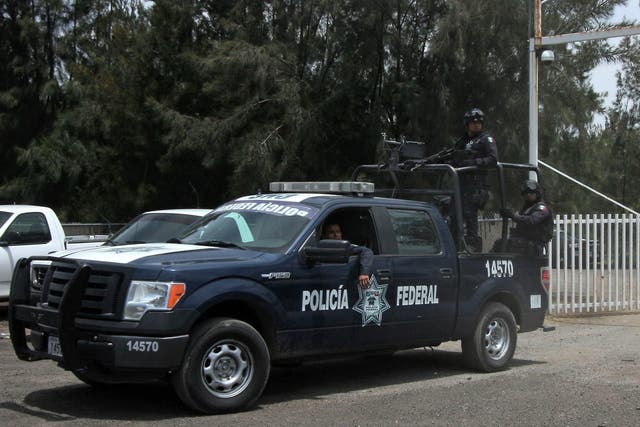 Mexican federal police outside the ranch where the alleged executions took place in May 2015 <em>Hector Guerrero/Getty</em>