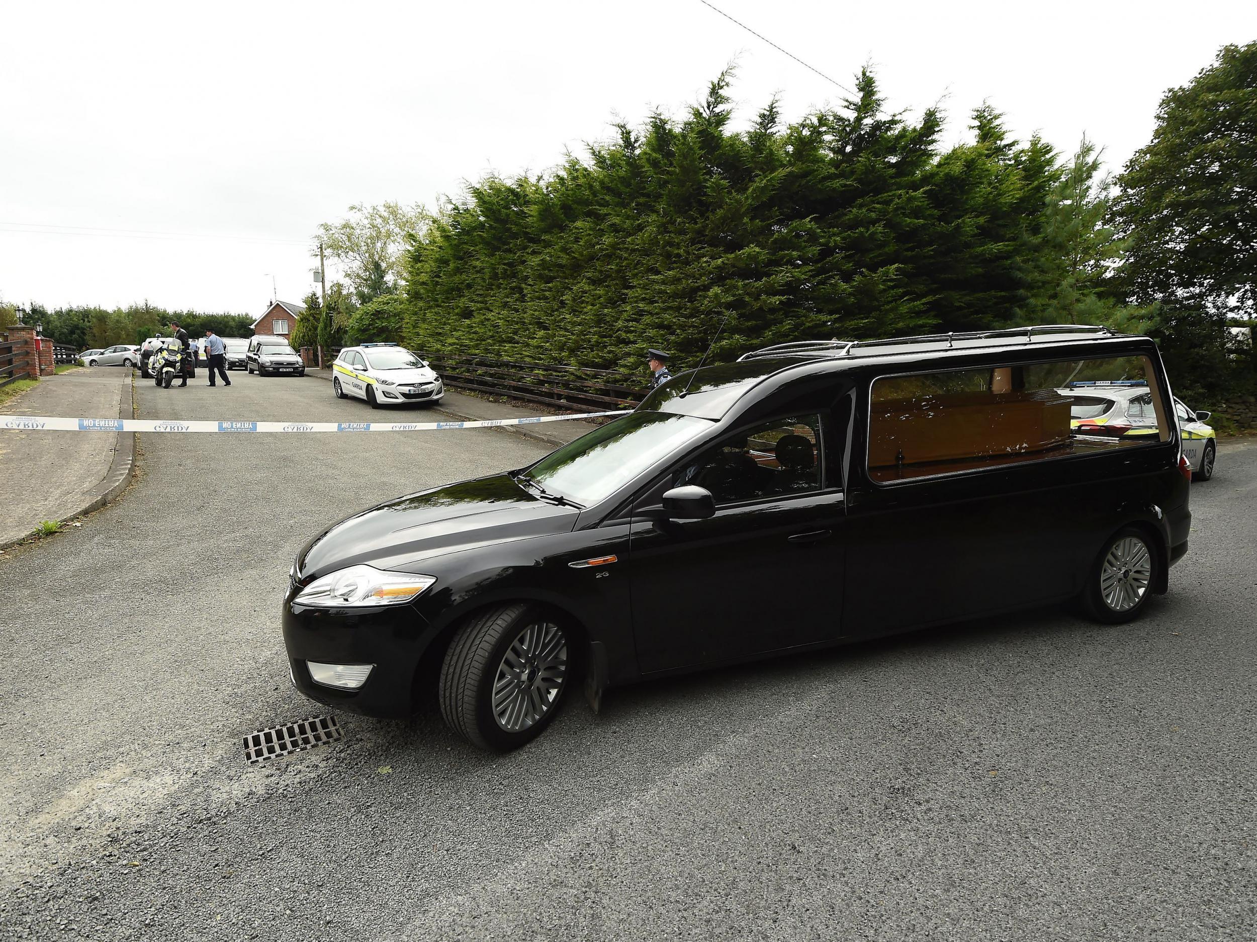 A hearse leaves the scene at Oakdene, Barconey, Ballyjamesduff in Cavan, where a family of five were found dead in their countryside home
