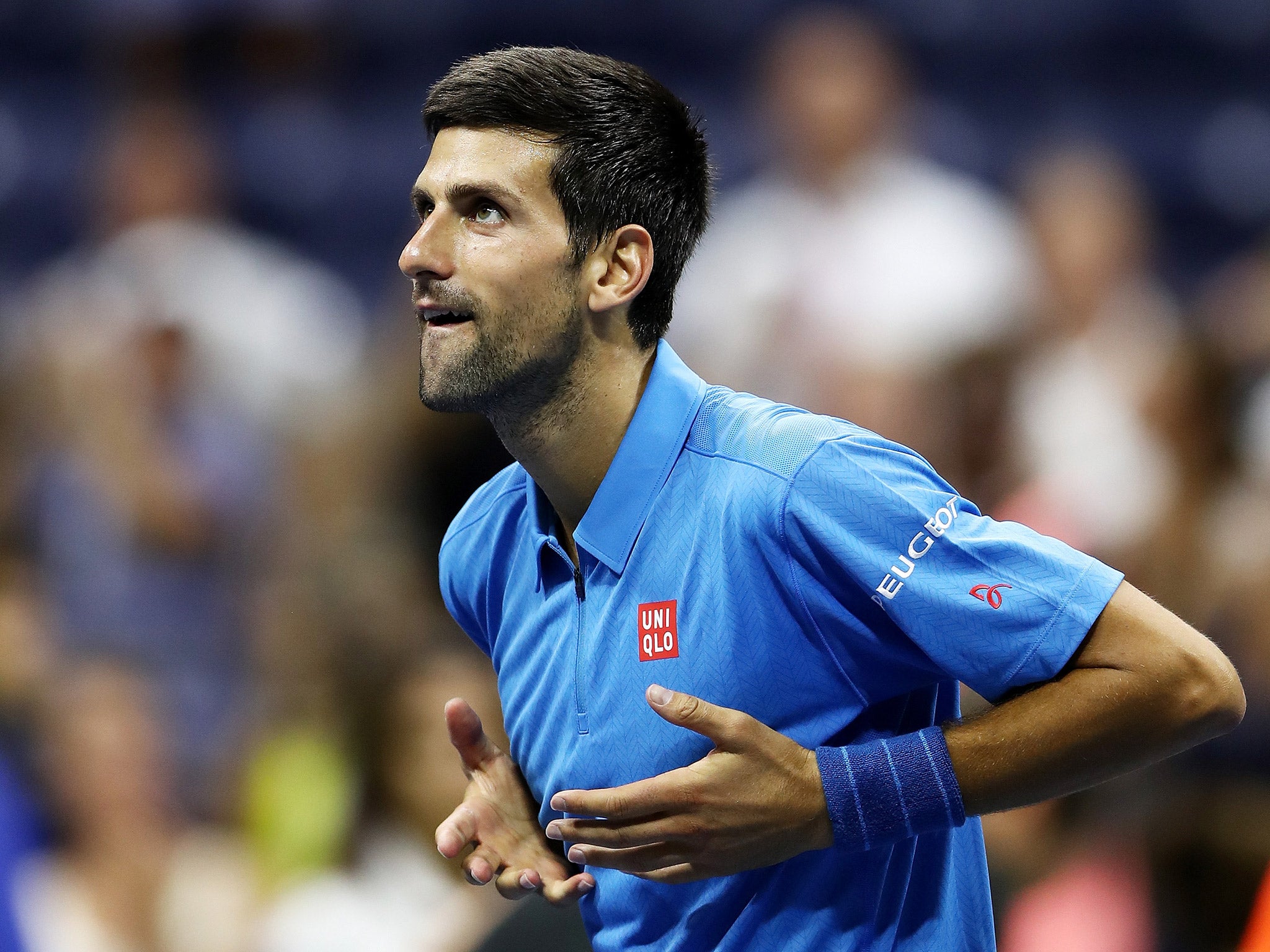 Novak Djokovic celebrates after beating Jerzy Janowicz in the first round of the US Open