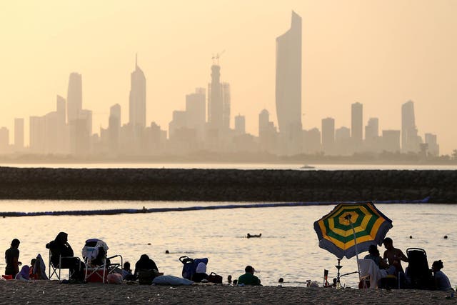 People sunbathe and swim at the Marina Crescent beach resort in the Salmiya district, some 20 kilometres east of the Kuwaiti capital Kuwait City