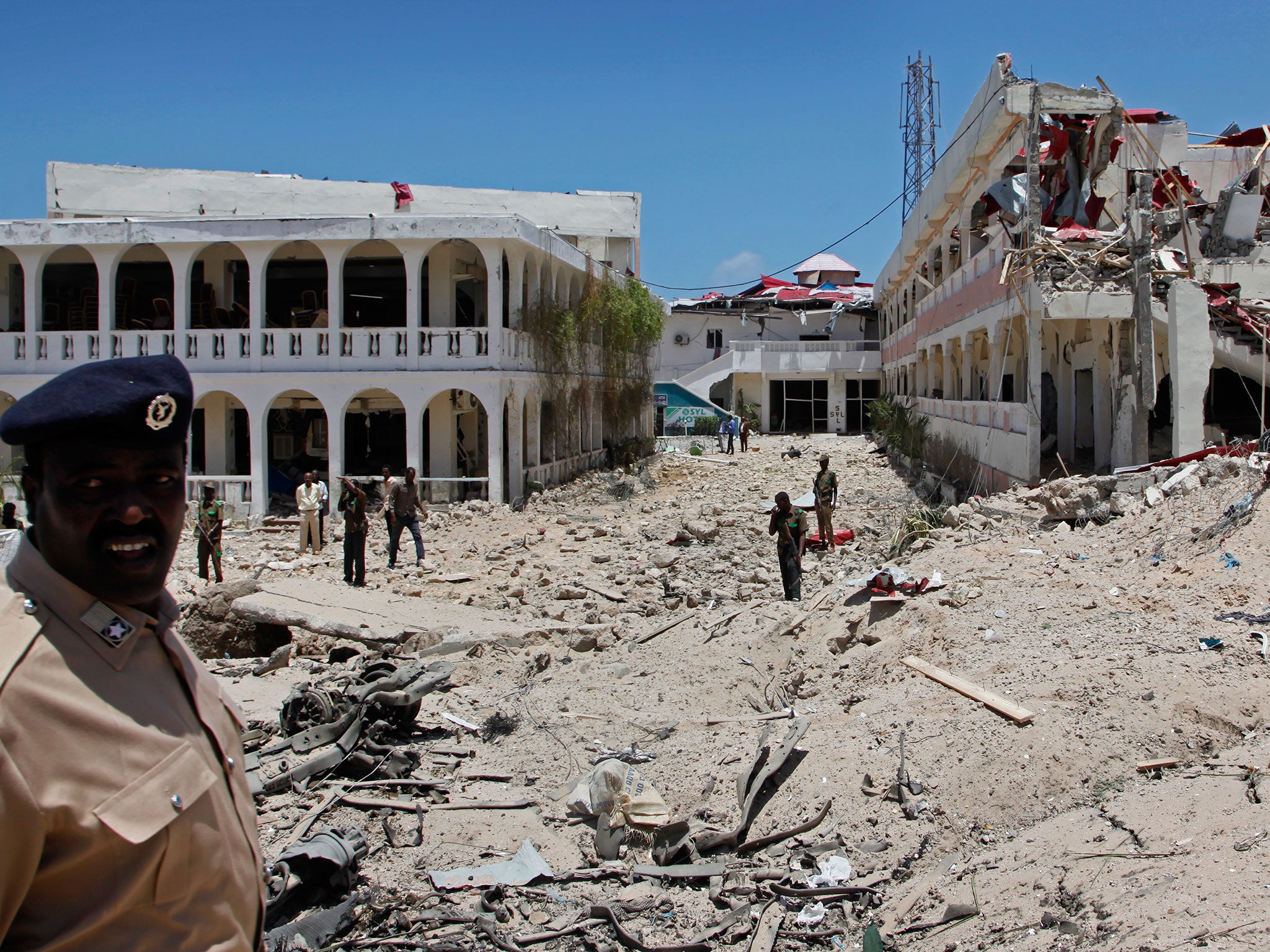 Soldiers near a building destroyed by a blast near the presidential palace in Mogadishu, Somalia, on 30 August