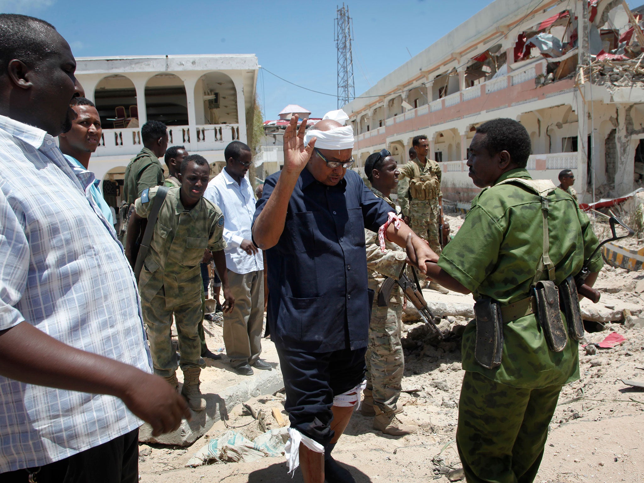 A soldier helps Somali politician Abdalla Bos Ahmed after he was injured by a blast near the presidential palace in Mogadishu yesterday